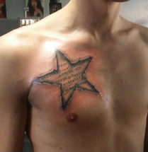 3D star tattoo with text in it on the chest