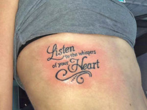 tattoo listen to the whispers of your heart in sierlijke letters